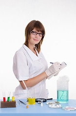 Image showing Pharmacist writing in a notebook