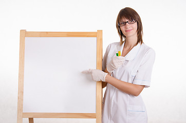 Image showing Chemist with test tubes at the board