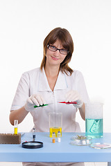Image showing Chemist mixes the two liquids