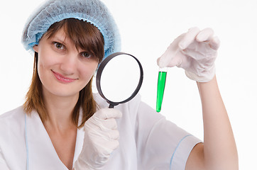 Image showing Pharmacist considers the liquid in a test tube