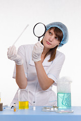 Image showing Chemist examines the foam on a stick