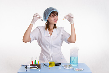 Image showing Lab technician with powders in vials