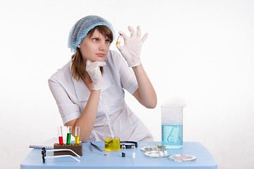 Image showing Chemist studying powder in the vial
