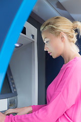 Image showing Lady using an atm counter