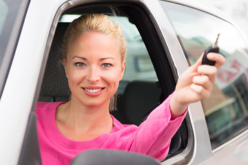 Image showing Caucasian lady showing a car key.