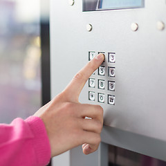 Image showing Women's hand using a dial pad