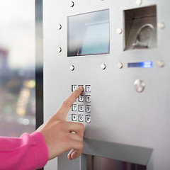 Image showing Women's hand using a dial pad