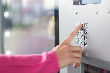 Image showing Women's hand using a dial pad