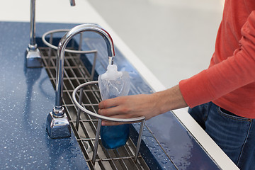 Image showing man refilling bottle