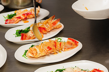 Image showing Decorating cooked lobster on plate