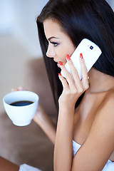 Image showing Young woman listening to a mobile phone call