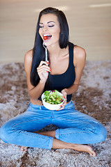 Image showing Healthy young woman enjoying a fresh salad