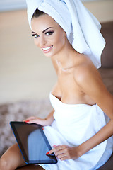 Image showing Woman Wearing Bath Towel Using Tablet Computer