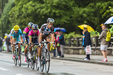 Image showing Group of Cyclists Riding in the Rain