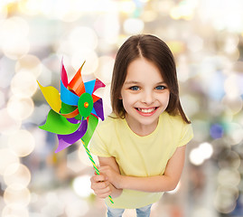 Image showing smiling child with colorful windmill toy