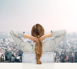 Image showing businesswoman sitting on chair from back