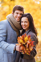 Image showing smiling couple hugging in autumn park