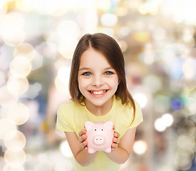 Image showing beautiful little girl with piggy bank