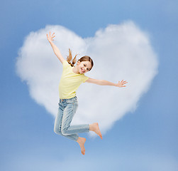 Image showing smiling little girl jumping