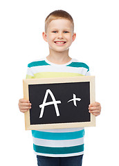 Image showing smiling little boy with blank blackboard