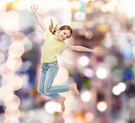 Image showing smiling little girl jumping