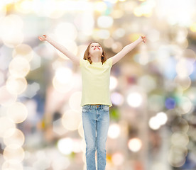 Image showing smiling teenage girl with raised hands