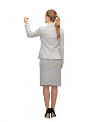 Image showing businesswoman or teacher with marker from back