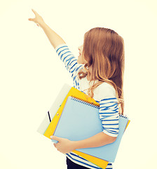 Image showing little student girl with notebooks pointing to