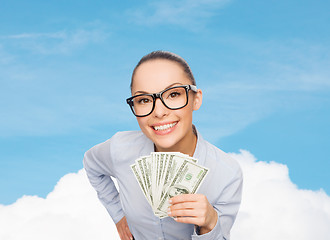 Image showing smiling businesswoman with dollar cash money