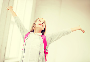 Image showing happy teenage girl with raised hands