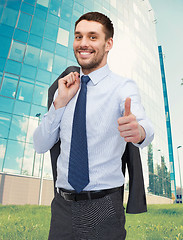 Image showing smiling young businessman showing thumbs up