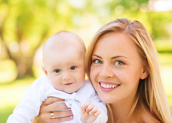 Image showing close up of happy mother with little baby in park