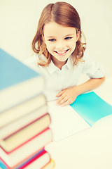 Image showing smiling little student girl with many books