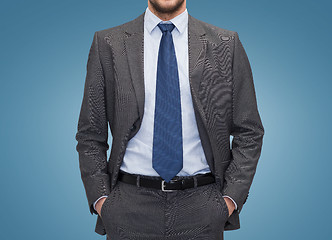 Image showing close up of businessman over blue background