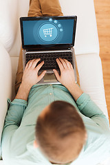 Image showing close up of man working with laptop at home