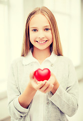 Image showing beautiful teenage girl showing red heart