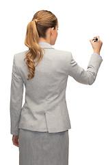 Image showing businesswoman or teacher with marker from back