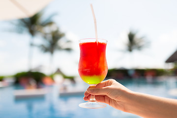 Image showing close-up of hand holding glass with cocktail