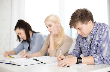 Image showing tired students with notebooks at school