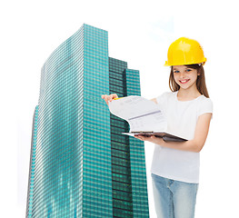 Image showing smiling little girl in hardhat with clipboard