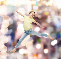 Image showing smiling little girl jumping