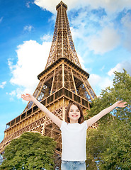 Image showing smiling teenage girl with raised hands