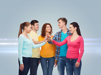 Image showing smiling teenagers making high five