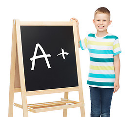 Image showing smiling little boy with blank blackboard