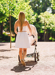 Image showing happy mother with stroller in park