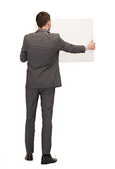 Image showing businessman or teacher with white board from back