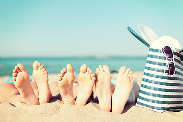 Image showing three women lying on the beach