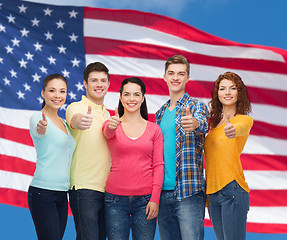 Image showing group of smiling teenagers over american flag