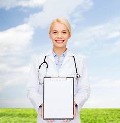 Image showing smiling female doctor with clipboard