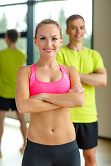 Image showing smiling man and woman in gym